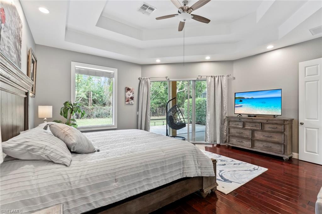 6051 Shallows Way Naples, FL 34109 - Photo 23 of 38 a bedroom with a bed and a flat screen tv