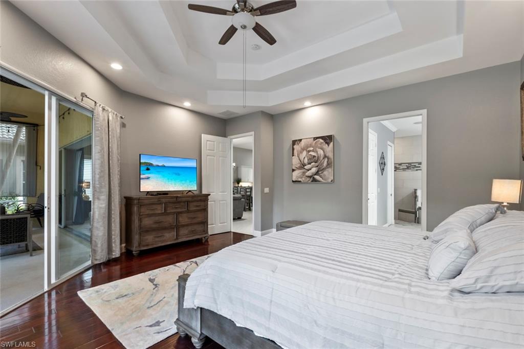 6051 Shallows Way Naples, FL 34109 - Photo 24 of 38 a bedroom with a bed and a flat screen tv