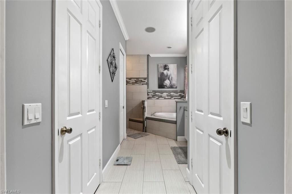 6051 Shallows Way Naples, FL 34109 - Photo 25 of 38 a bathroom with a sink toilet and shower