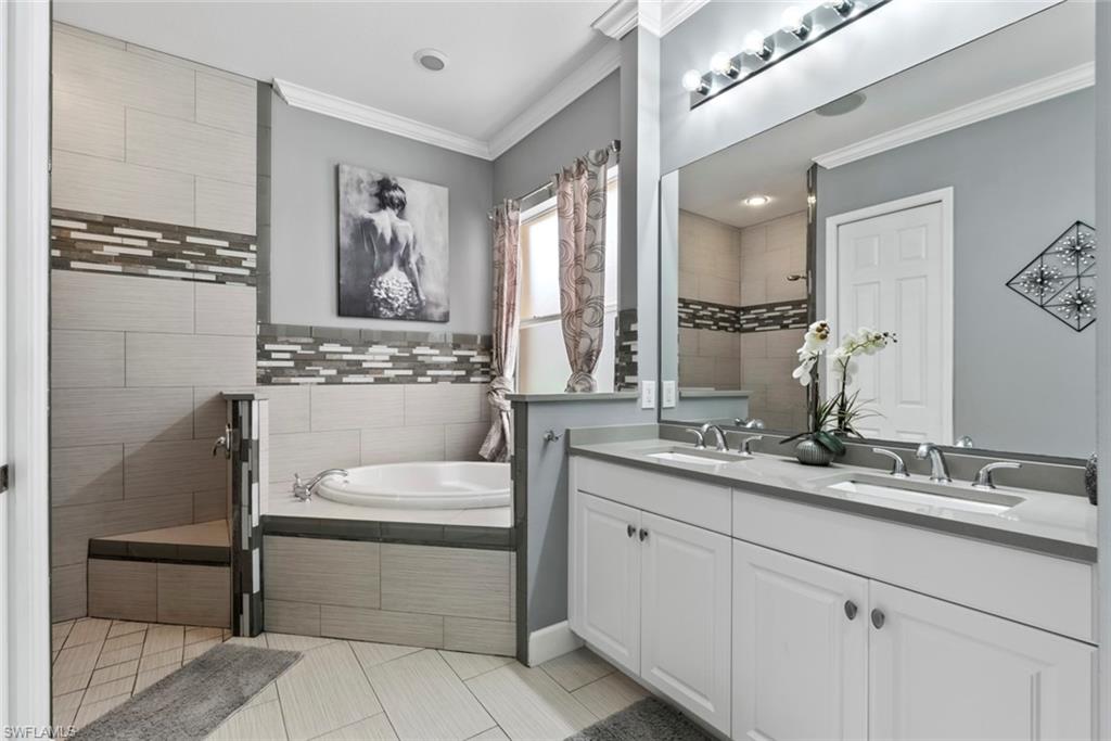6051 Shallows Way Naples, FL 34109 - Photo 26 of 38 a bathroom with a sink a vanity and mirror