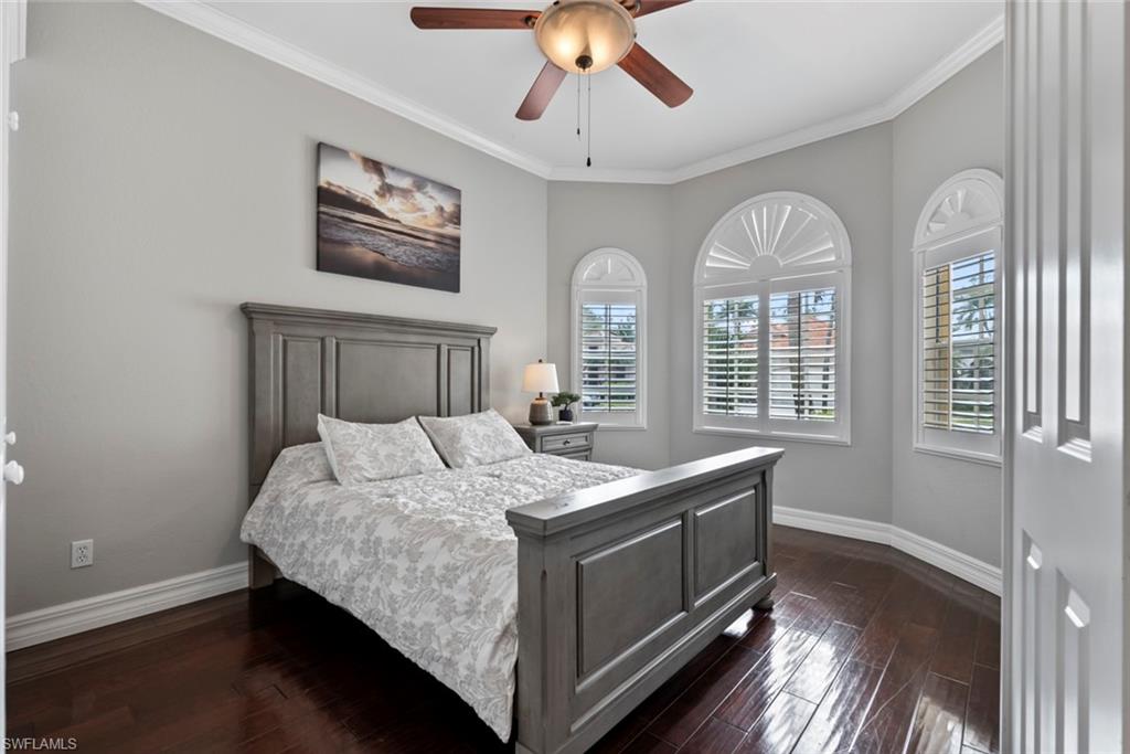 6051 Shallows Way Naples, FL 34109 - Photo 28 of 38 a bedroom with a bed and a chandelier
