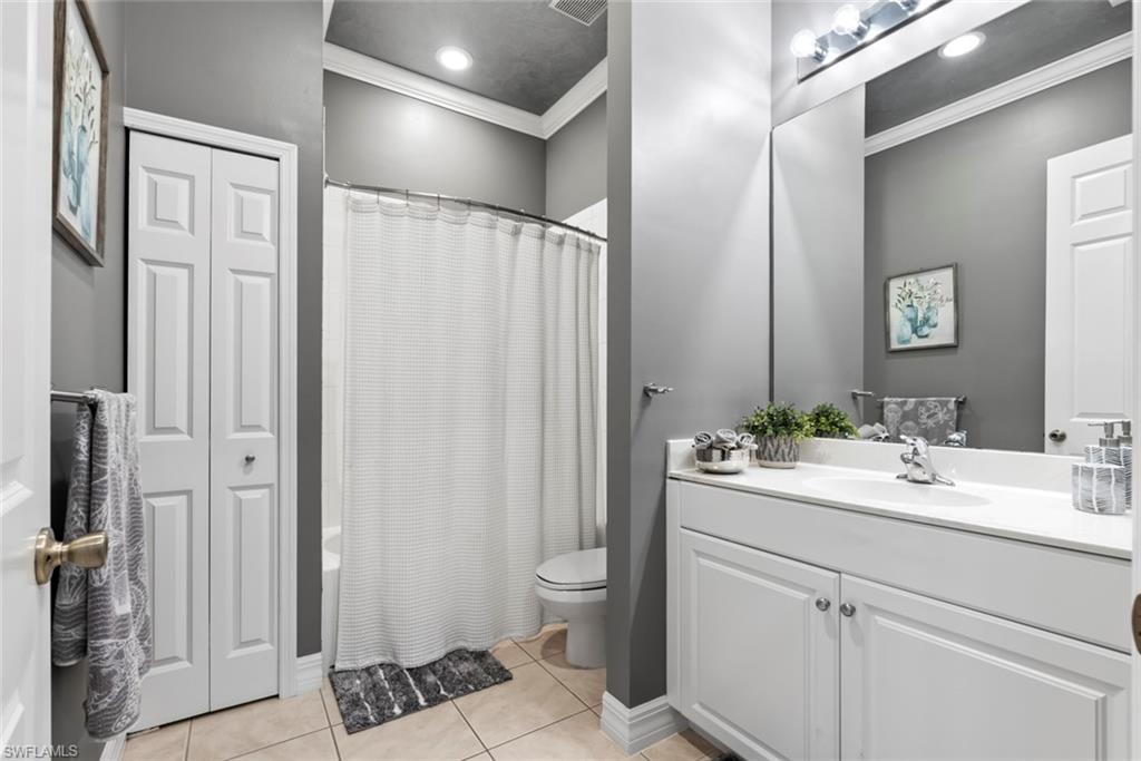 6051 Shallows Way Naples, FL 34109 - Photo 30 of 38 a bathroom with a sink a toilet and shower
