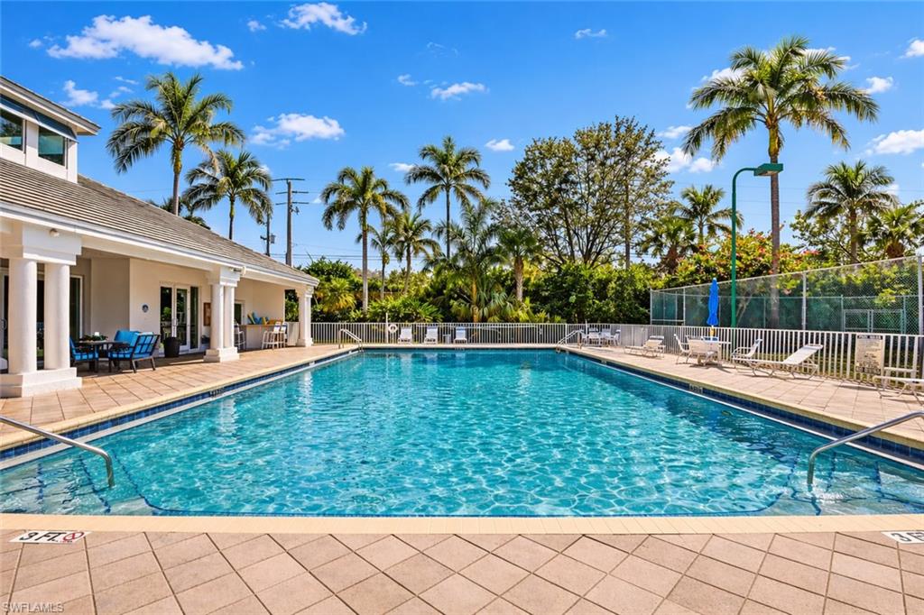 6051 Shallows Way Naples, FL 34109 - Photo 33 of 38 a view of a swimming pool with a patio