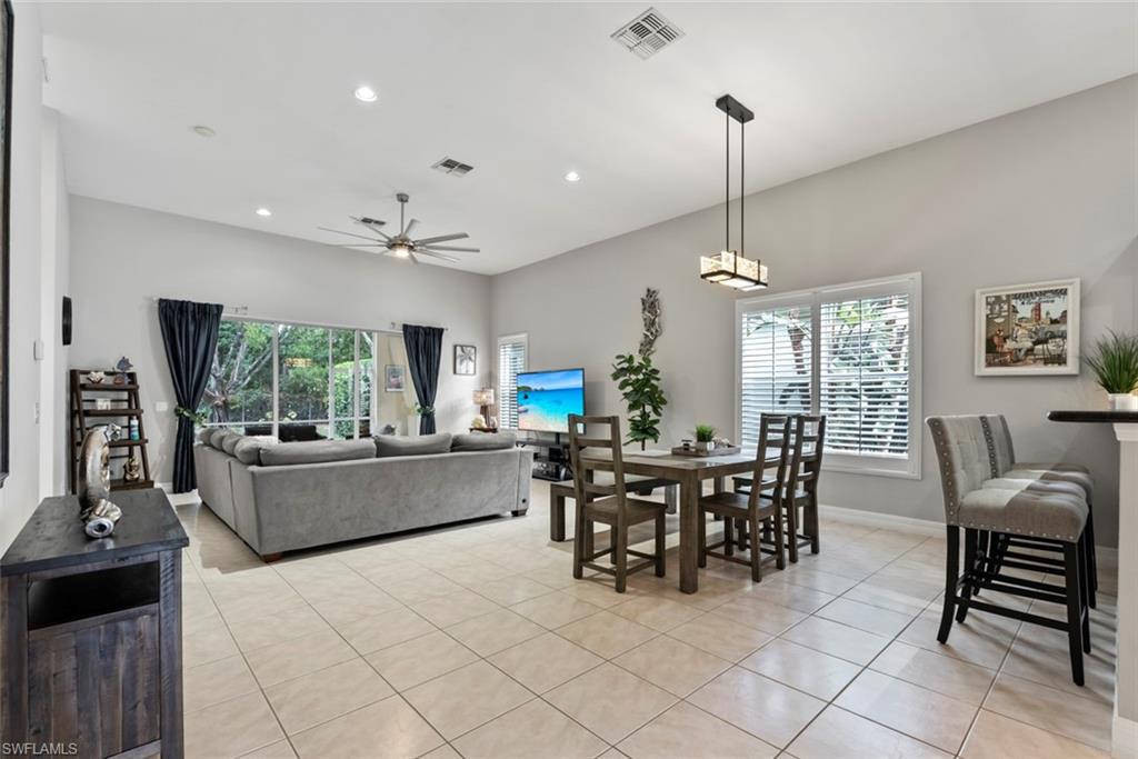 6051 Shallows Way Naples, FL 34109 - Photo 8 of 38 a dining room with furniture and window