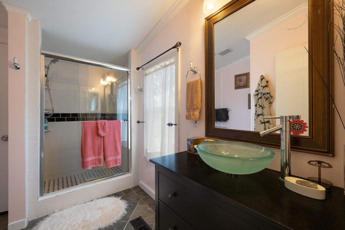3307 Sunset Cliff Road Burnet, TX 78611 - Photo 18 of 23 a bathroom with a granite countertop sink a mirror and shower