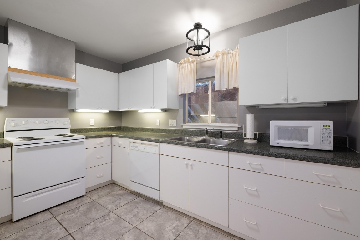 3307 Sunset Cliff Road Burnet, TX 78611 - Photo 9 of 23 a kitchen with granite countertop white cabinets and white appliances