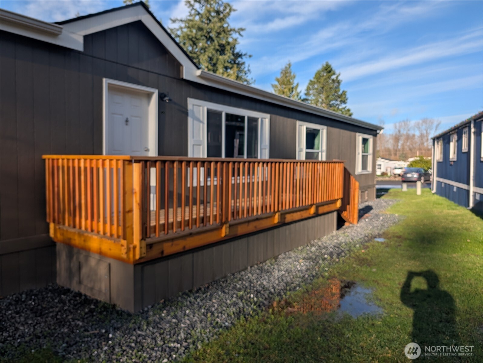 a view of a house with backyard and sitting area