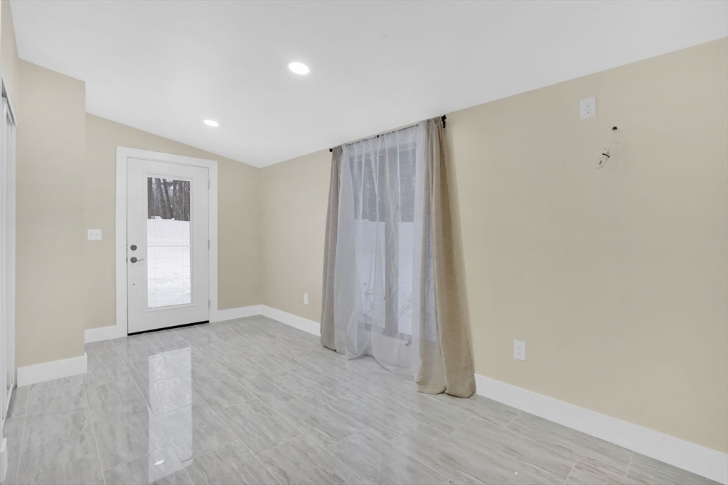 288 Buck Pond Road Westfield, MA 01085 - Photo 13 of 38 an empty room with wooden floor and windows