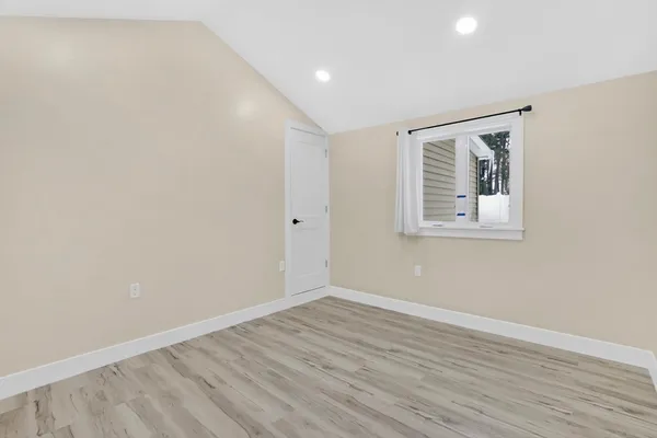 a view of room with window and wooden floor