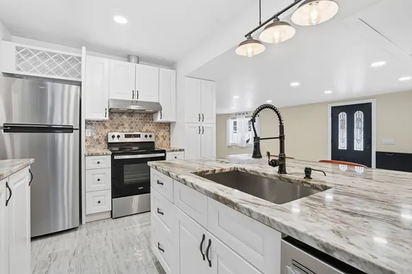 a kitchen with a refrigerator and a sink