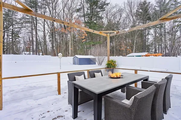 a backyard of a house with barbeque oven table and chairs