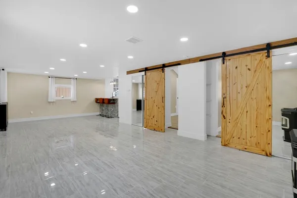 a view of empty room with wooden floor