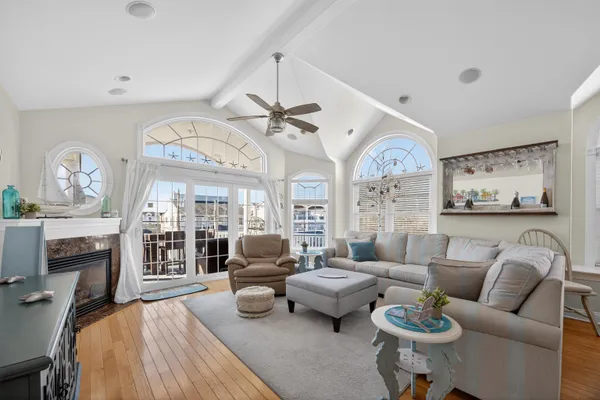a living room with furniture a fireplace and a large window