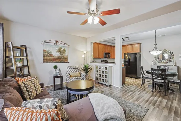 a living room with furniture a dining table and a fireplace