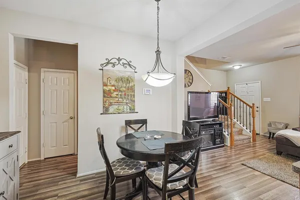 a view of a dining room with furniture and wooden floor