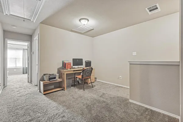 a work room with furniture and a ceiling fan