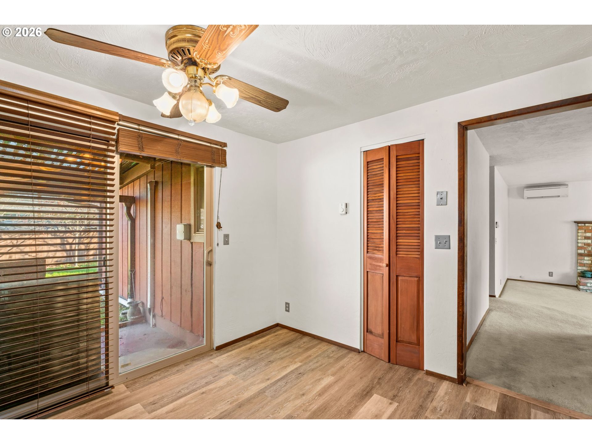 1625 South Bertelsen Road Eugene, OR 97402 - Photo 14 of 34 an empty room with wooden floor chandelier fan and windows
