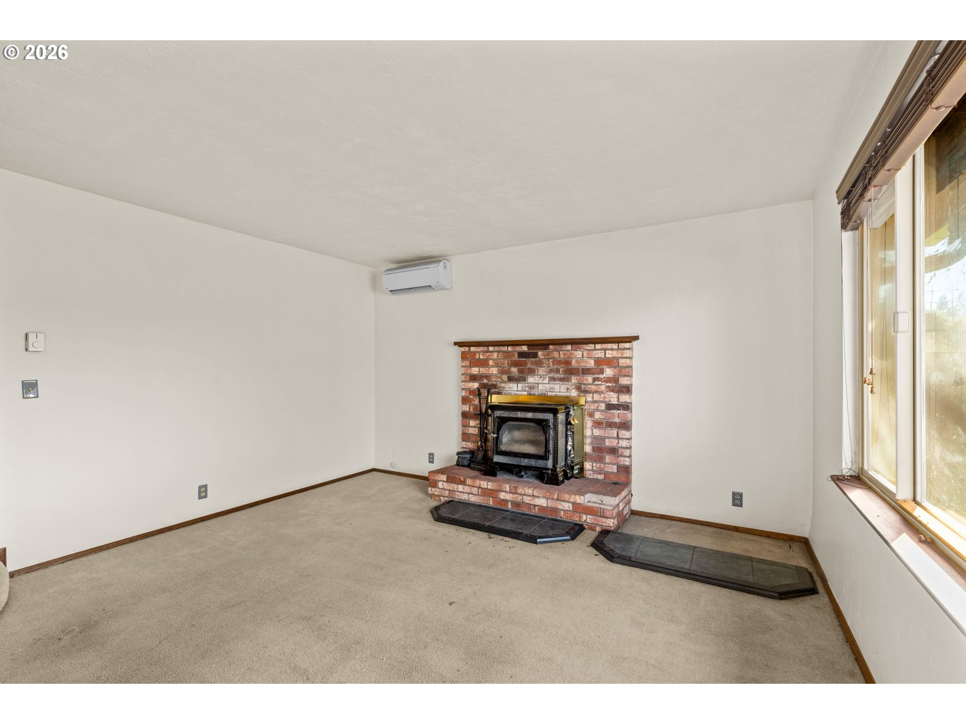 1625 South Bertelsen Road Eugene, OR 97402 - Photo 8 of 34 a living room with furniture a fireplace and a large window