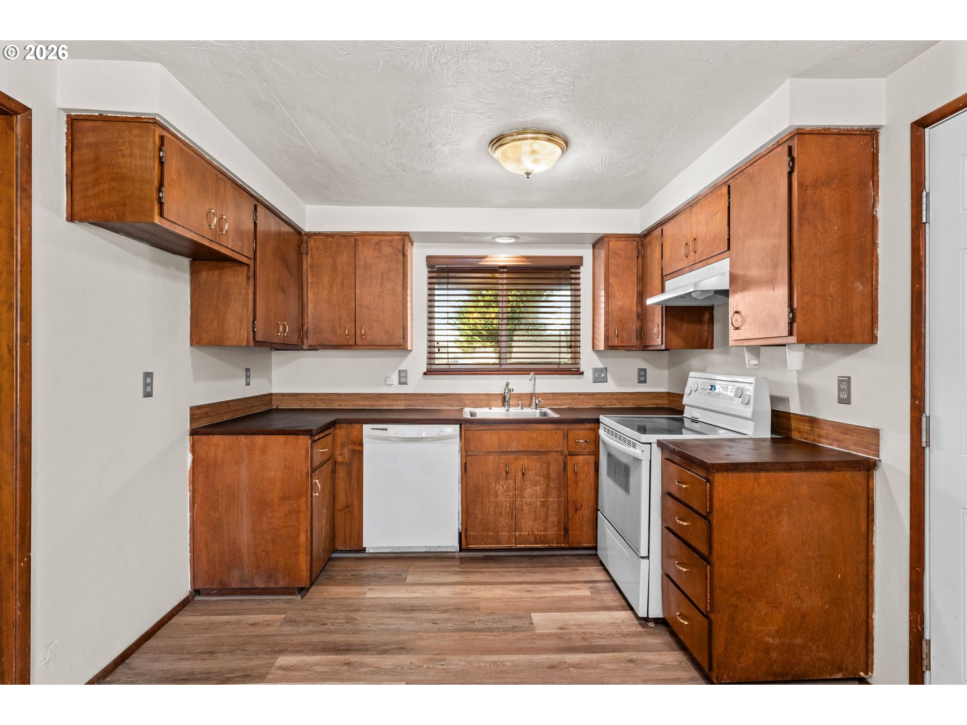 1625 South Bertelsen Road Eugene, OR 97402 - Photo 10 of 34 a kitchen with stainless steel appliances granite countertop a stove a sink dishwasher and a microwave oven with cabinets
