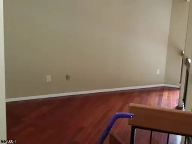 a view of a small space with wooden floor and a window