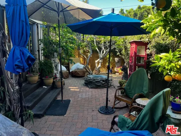 a view of a chairs and table under an umbrella in patio