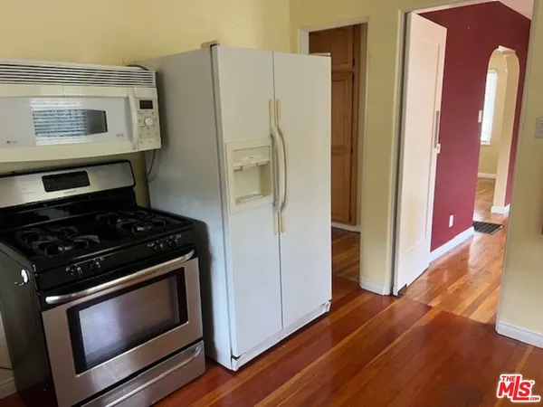 a kitchen with a stove and a refrigerator