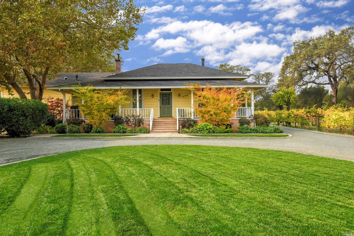 a front view of a house with a big yard