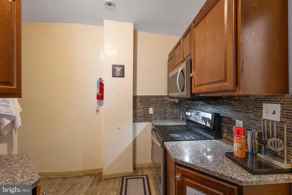 a kitchen with granite countertop a sink and cabinets