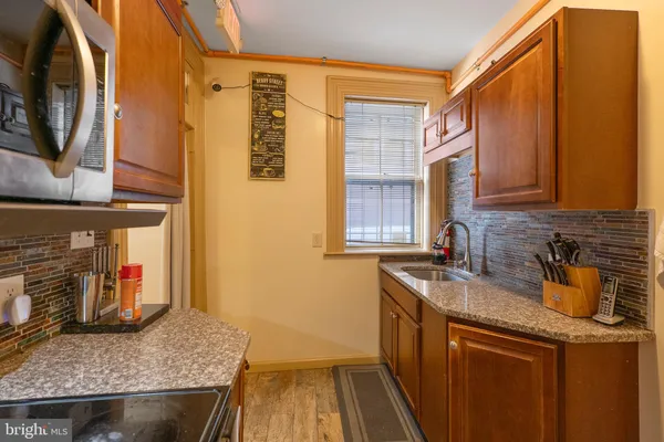 a kitchen with stainless steel appliances granite countertop a sink a stove and a microwave