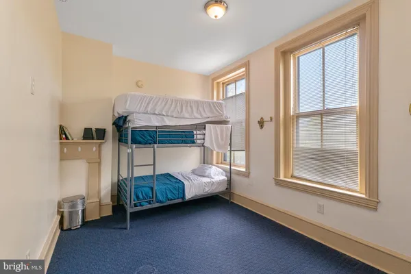 a bedroom with bed and a window