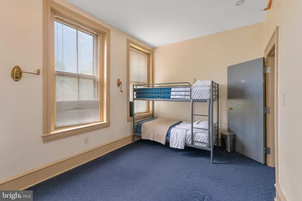 a bed room with a bed and a window