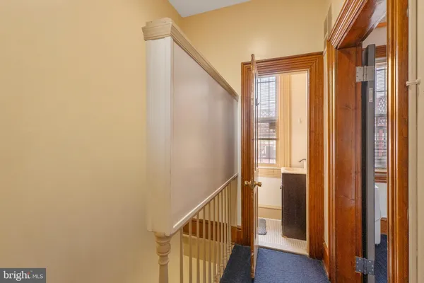 a view of a hallway with wooden floor and entryway