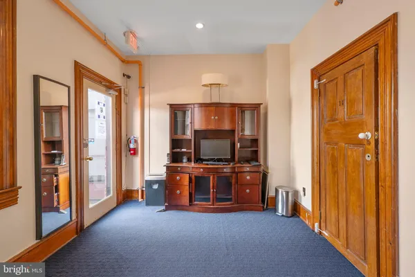 a view of a livingroom with kitchen and furniture