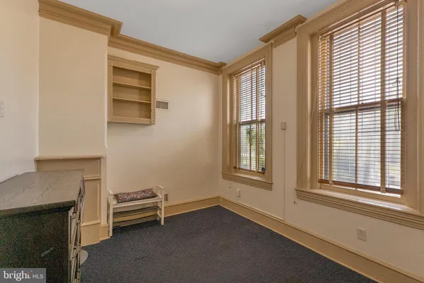 a view of room with window and furniture