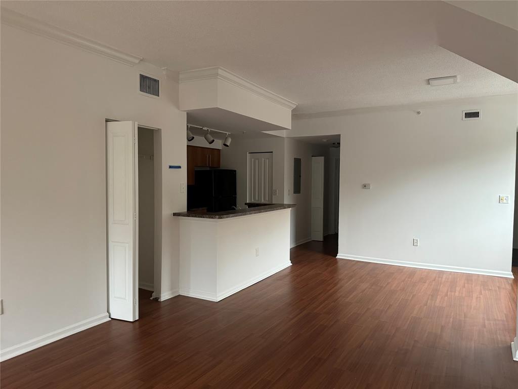 5800 West Sample Road, Unit 2011 Coral Springs, FL 33067 - Photo 11 of 25 a view of a big room with wooden floor and a bathroom