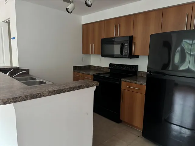 a kitchen with a sink and a microwave