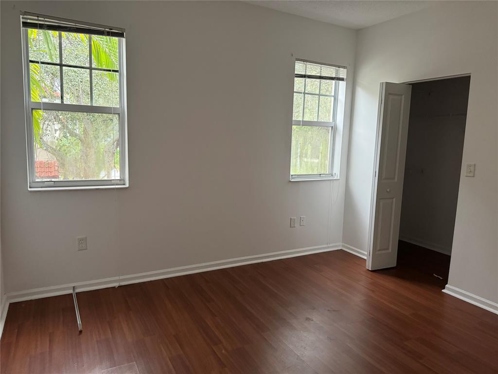 5800 West Sample Road, Unit 2011 Coral Springs, FL 33067 - Photo 20 of 25 an empty room with wooden floor and windows