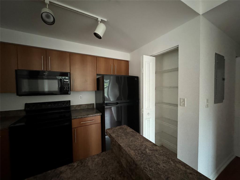 5800 West Sample Road, Unit 2011 Coral Springs, FL 33067 - Photo 25 of 25 a kitchen with a refrigerator stove and microwave