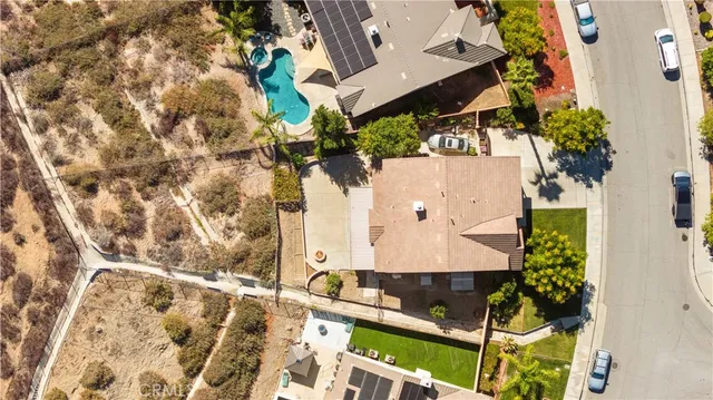 an aerial view of a house with a yard and large trees