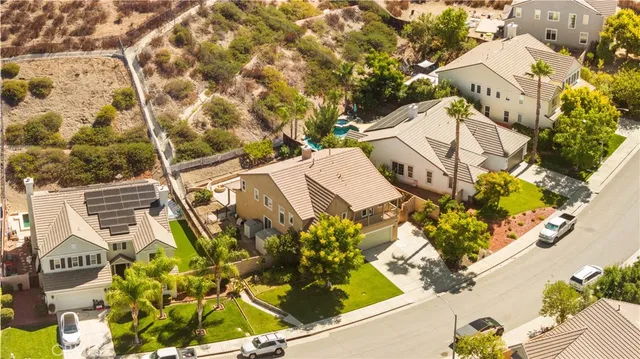 an aerial view of a house with a yard and garden
