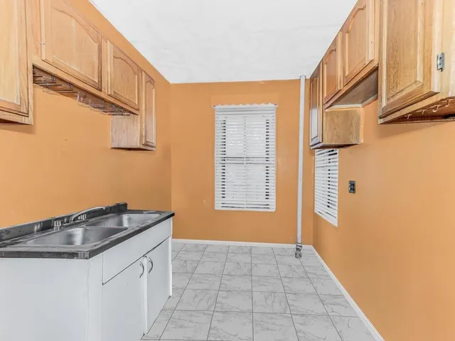 a kitchen with a sink and a window