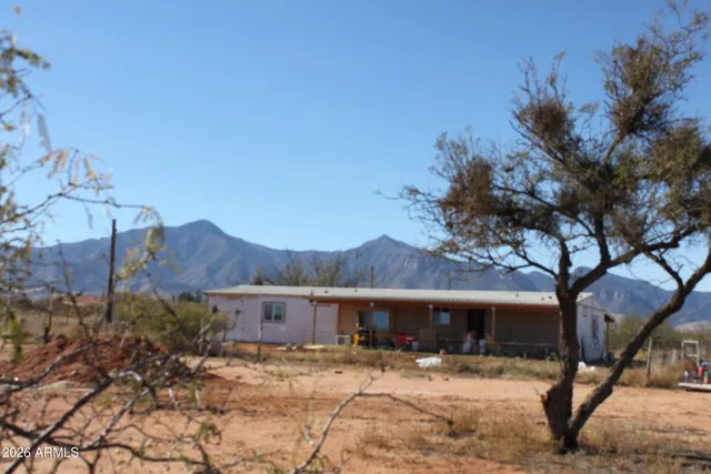 a view of a house with a yard covered with snow in the background
