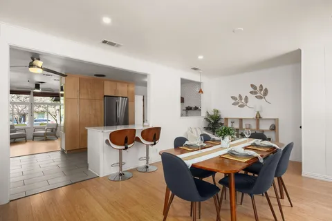 a view of a dining room with furniture and wooden floor