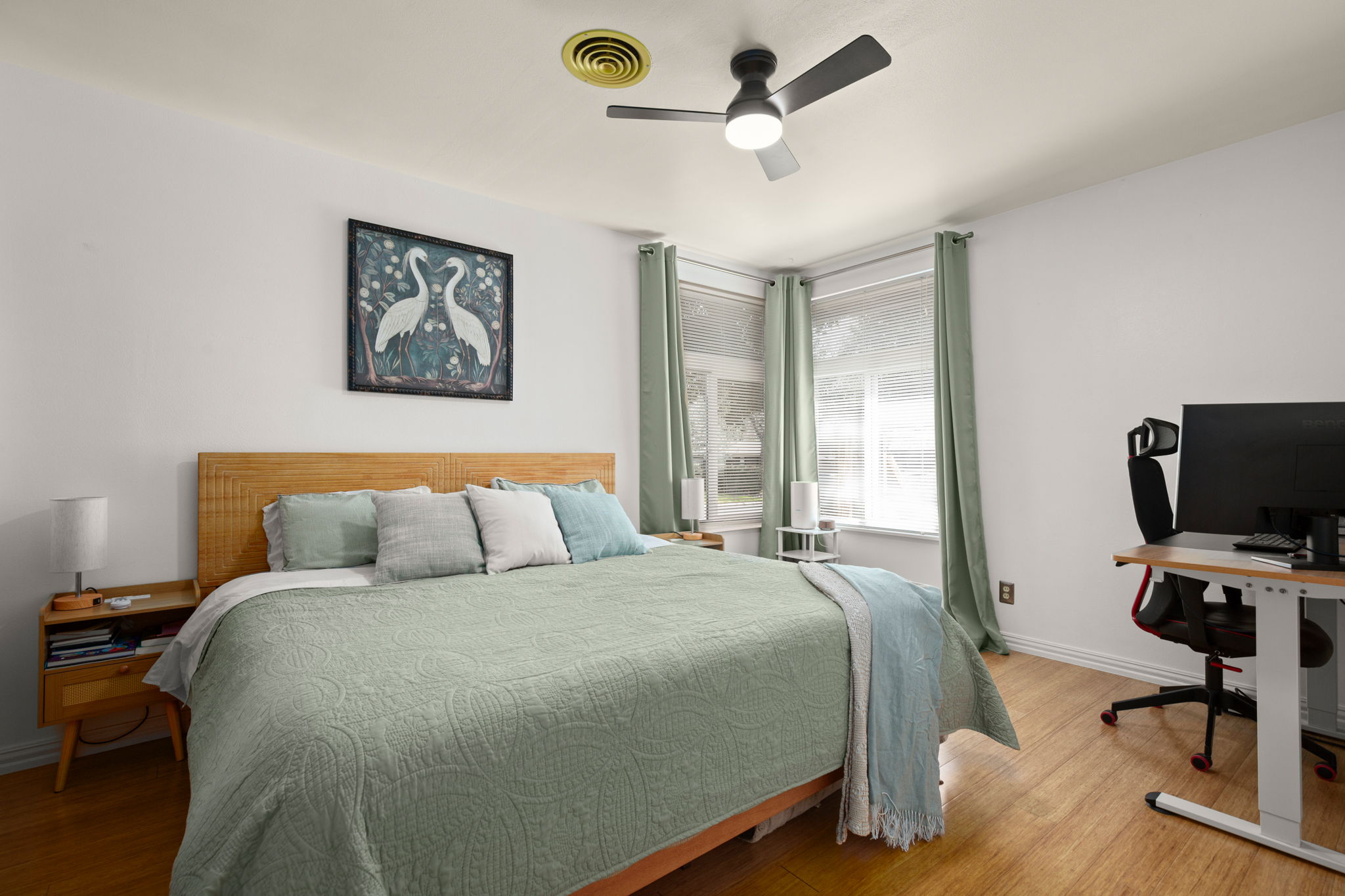 6304 Peggy Street Austin, TX 78723 - Photo 17 of 35 Bedroom featuring a desk, wood finished floors, and ceiling fan