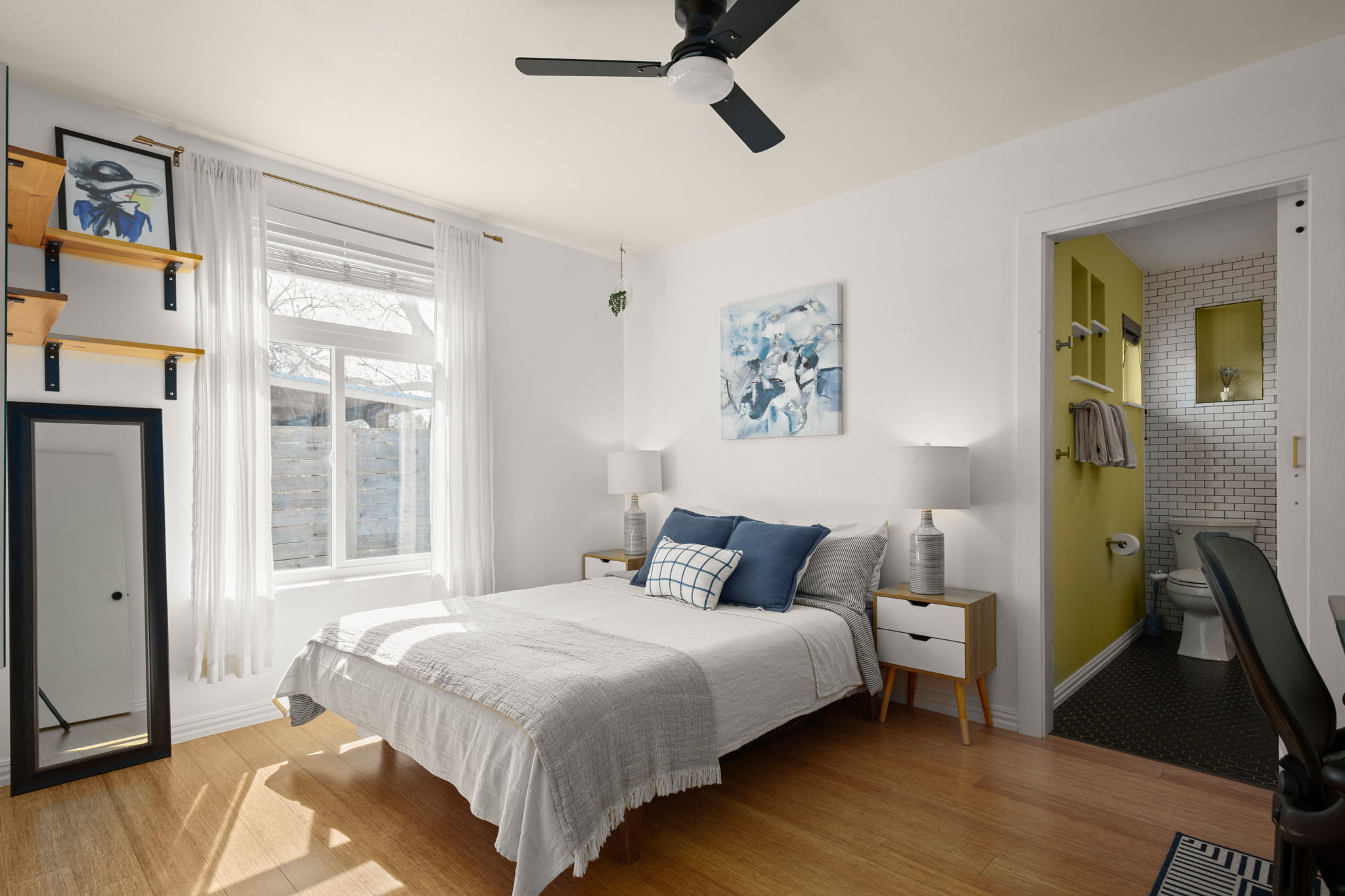 6304 Peggy Street Austin, TX 78723 - Photo 21 of 35 Bedroom featuring light wood-style floors, a ceiling fan, and ensuite bath