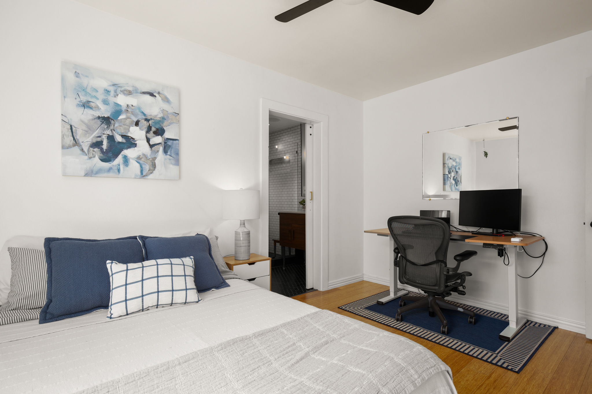 6304 Peggy Street Austin, TX 78723 - Photo 22 of 35 Bedroom featuring light wood-type flooring, a desk, ensuite bathroom, and ceiling fan