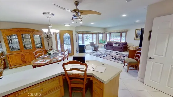 a view of a dining room with furniture a chandelier and window