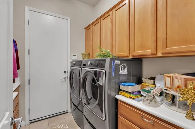 a view of a storage and utility room with washer and dryer