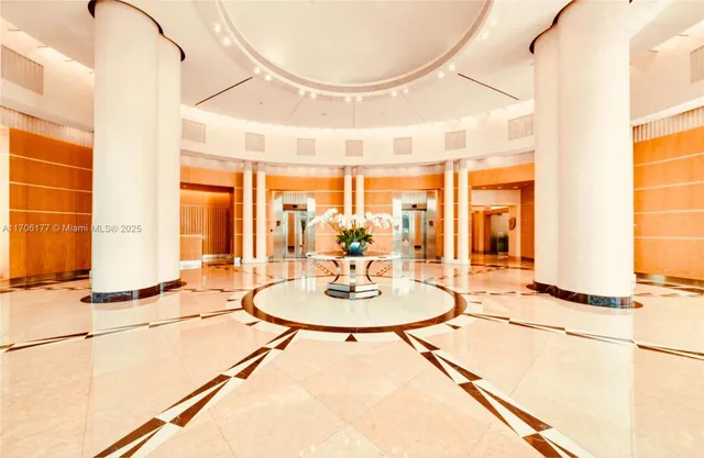 a living room with furniture a large window and chandelier