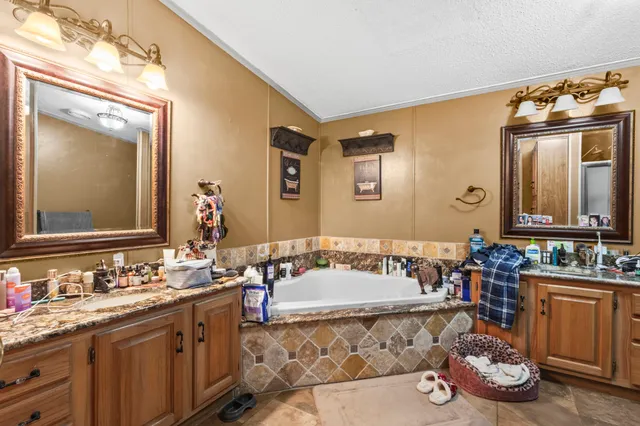 a bathroom with a tub sink and mirror